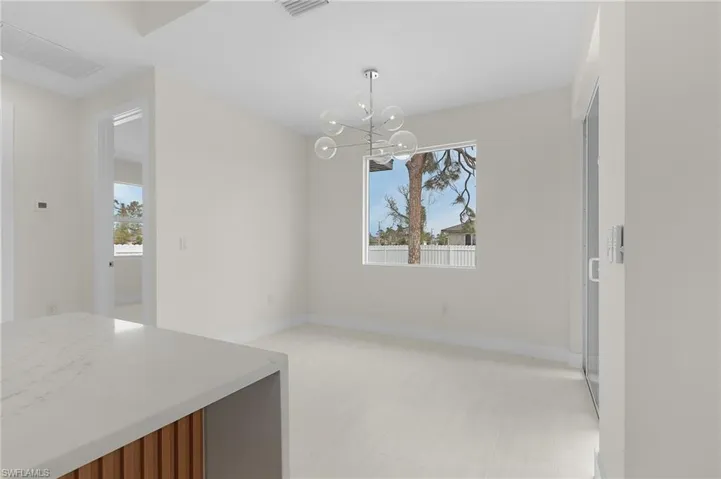 Unfurnished dining area with baseboards and a chandelier