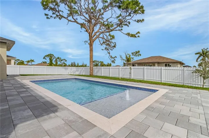 View of pool with a patio area and a fenced backyard