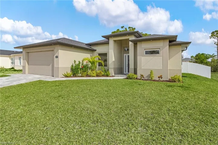 Prairie-style home featuring stucco siding, concrete driveway, and an attached garage