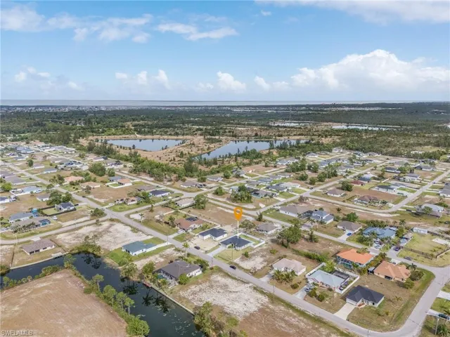 Aerial overview of property's location featuring a large body of water and nearby suburban area