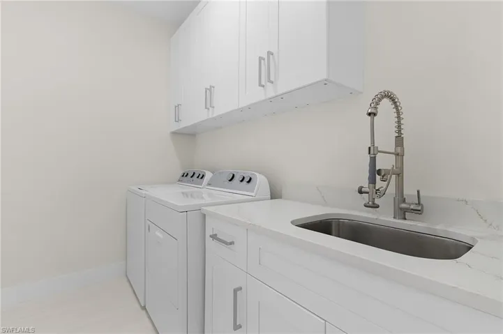 Laundry area featuring washer and dryer and cabinet space