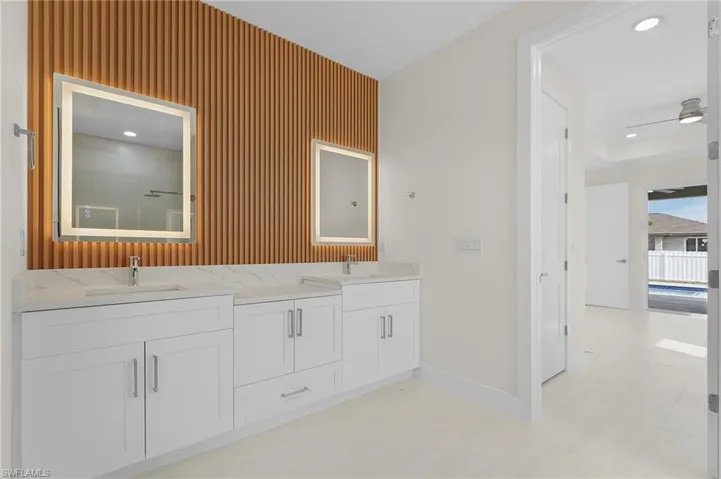 Full bathroom with recessed lighting and double vanity