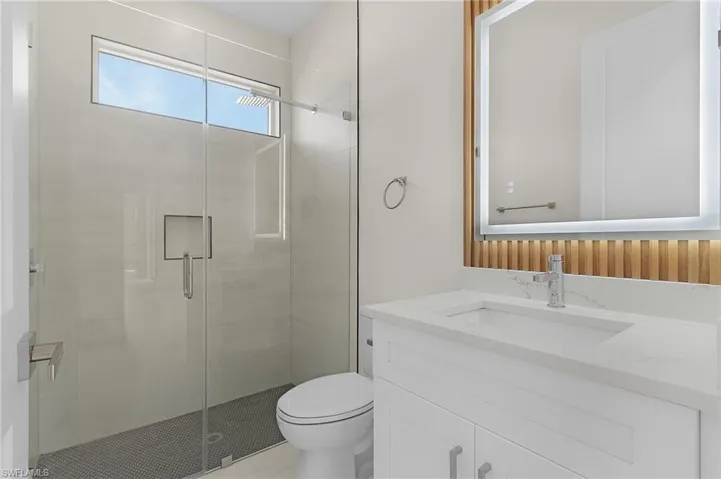 Full bathroom featuring a shower stall and vanity