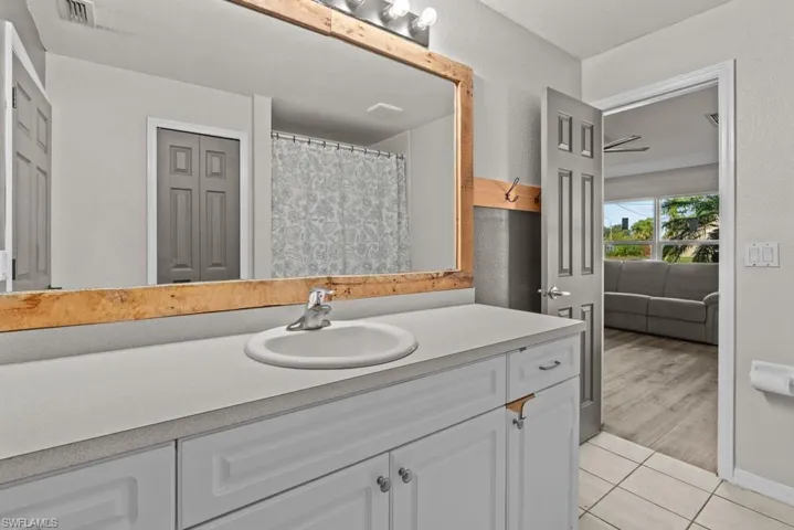 Full bathroom with tile patterned flooring and vanity