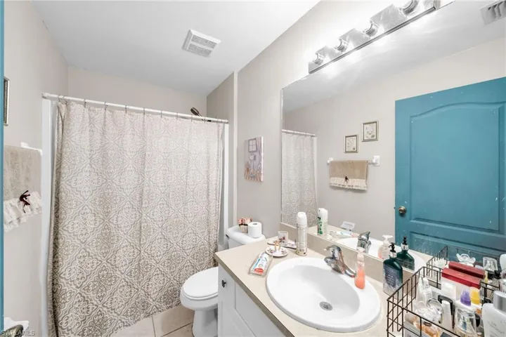 Bathroom featuring tile patterned flooring, vanity, and toilet