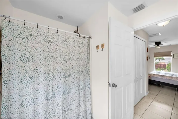 Bathroom featuring tile patterned flooring and ceiling fan