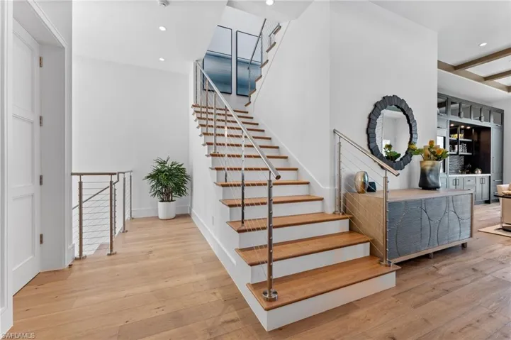 Stairway featuring wood-type flooring and recessed lighting