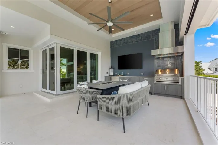 View of patio featuring area for grilling, exterior kitchen, and ceiling fan