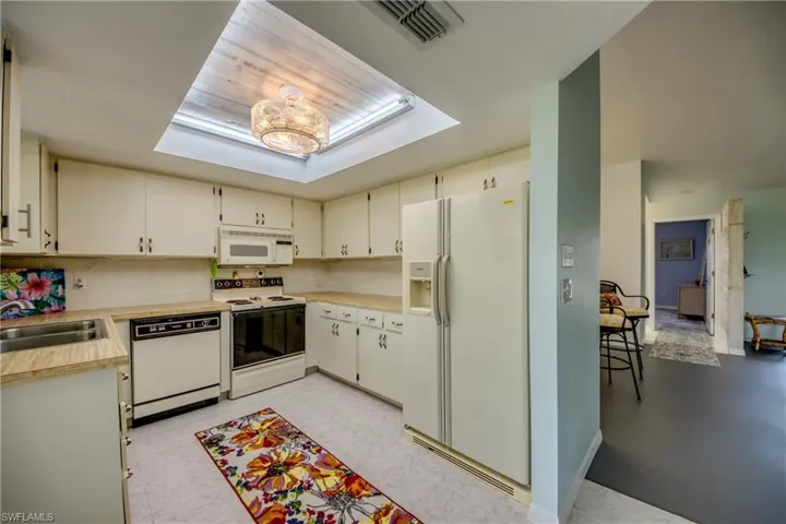 KITCHEN WITH NEW TRAY CEILING AND FAN WITH LIGHTS.