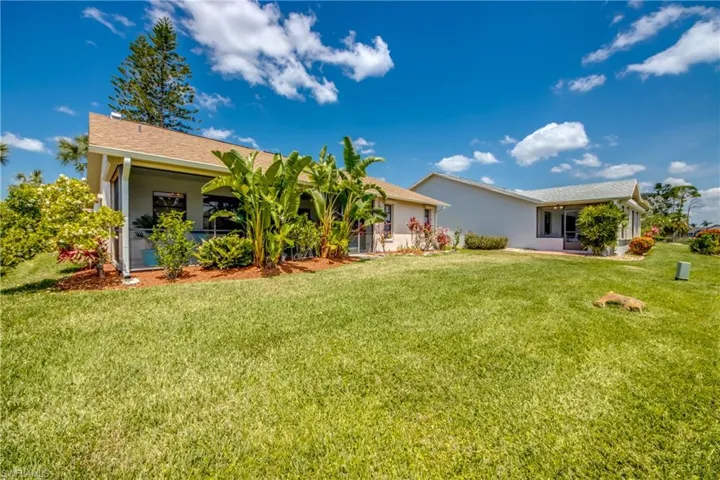 BACK OF HOME IS LANDSCAPED WITH BIRD OF PARADISE AND GARDENIA.
