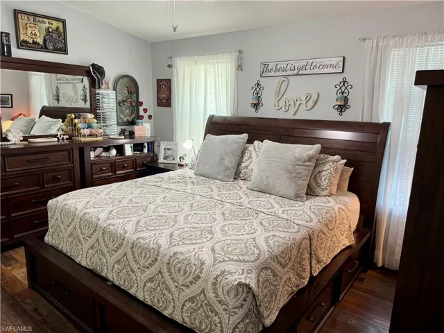 Bedroom with dark wood finished floors