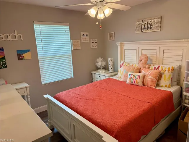 Bedroom featuring dark wood-type flooring and ceiling fan
