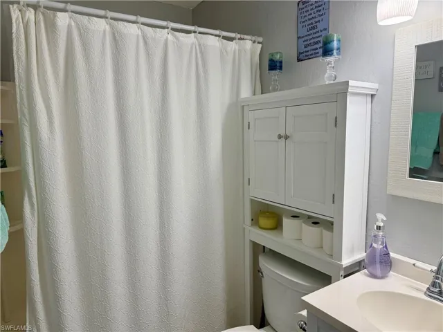 Bathroom featuring vanity and a shower with shower curtain