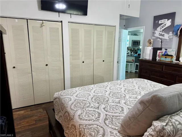 Bedroom featuring two closets and dark wood finished floors