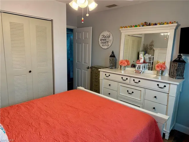 Bedroom with a closet and dark wood-type flooring