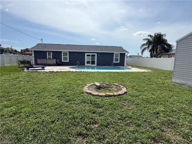 Back of property featuring a patio area, an outdoor fire pit, and a fenced backyard