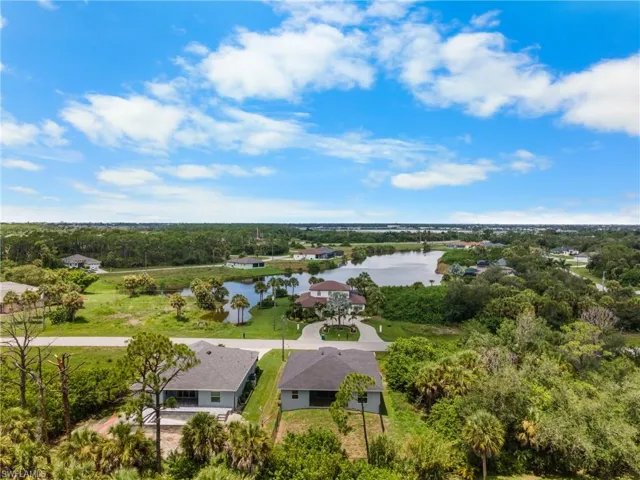 Aerial perspective of a neighborhood featuring a prominent body of water