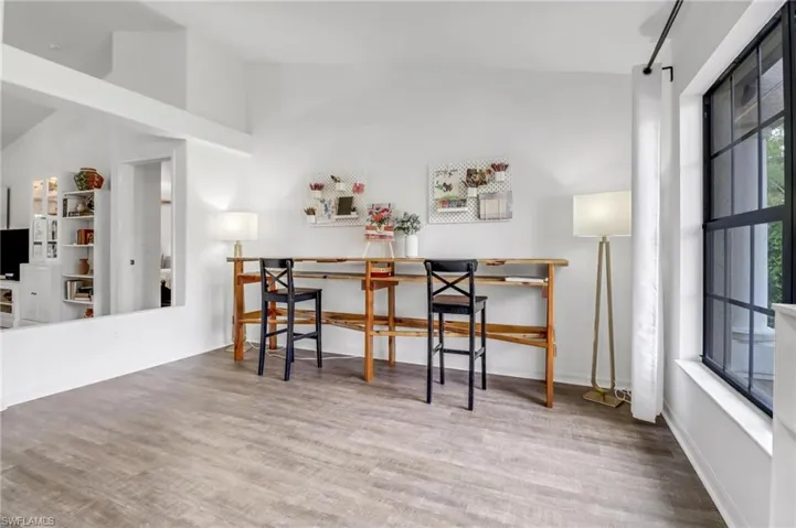 Dining area featuring high vaulted ceiling, hardwood / wood-style floors, and breakfast area