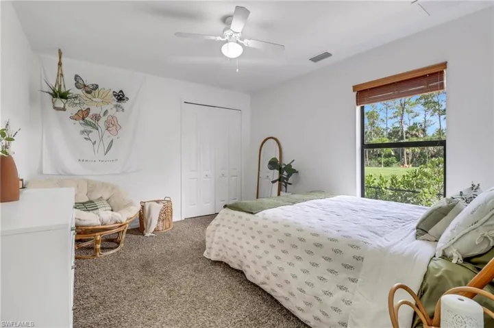 Bedroom featuring ceiling fan, a closet, and carpet flooring