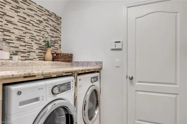 Washroom featuring washing machine and dryer
