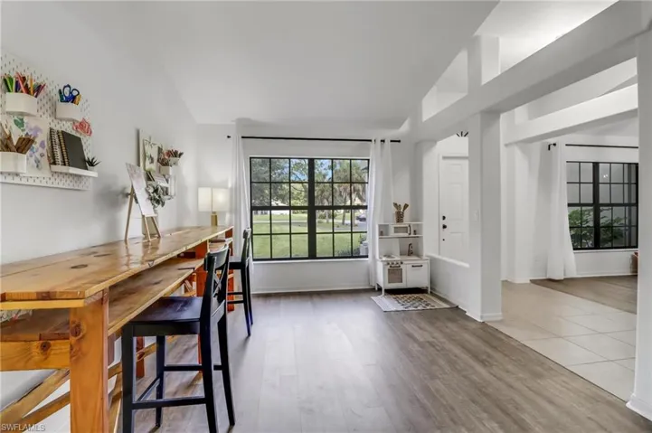 Dining space with lofted ceiling and hardwood / wood-style floors