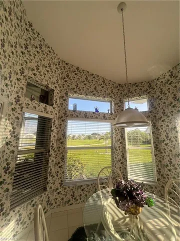 Dining area featuring a vaulted ceiling and an array of windows providing natural illumination and expansive exterior views