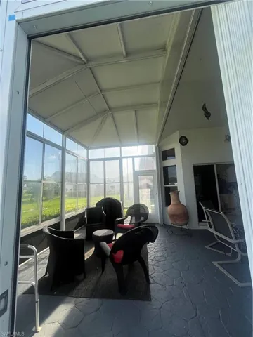 Expansive screened enclosure with a vaulted ceiling and a stone-patterned floor