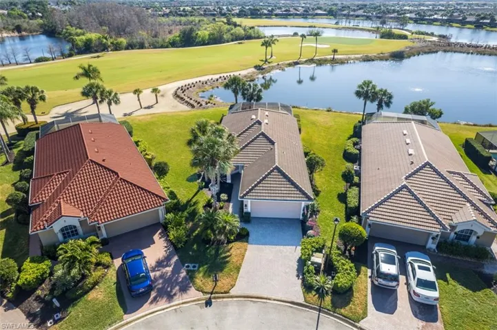 Aerial view of residential area with a large body of water and a local golf course
