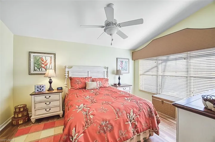 Bedroom featuring vaulted ceiling, a ceiling fan, and wood finished floors