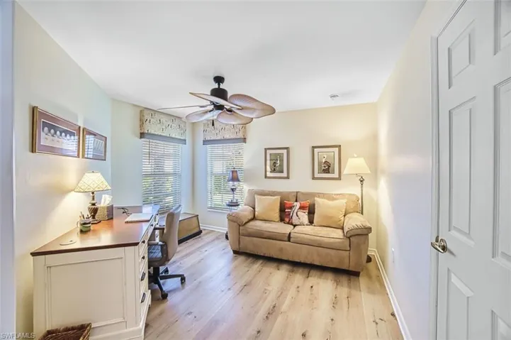 Office space with light wood finished floors and ceiling fan