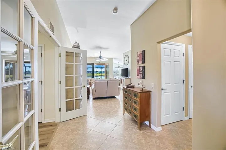 Hall with light tile patterned floors and baseboards