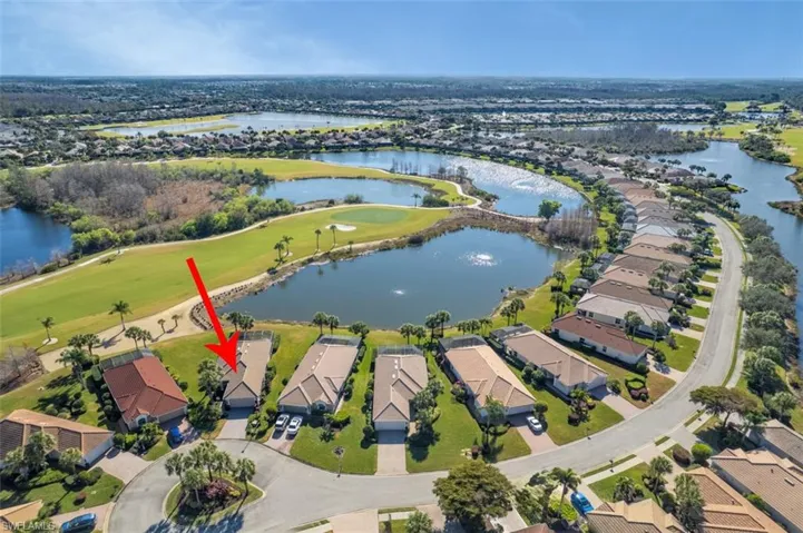 View of property location with a nearby body of water, nearby suburban area, and a local golf course