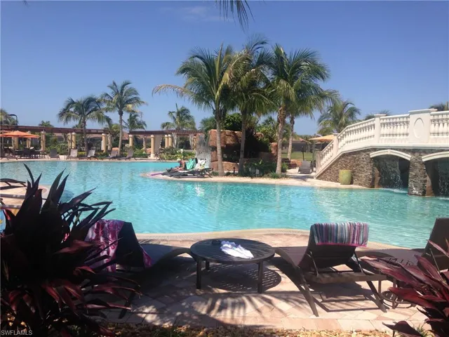 Community pool with a patio area and stairs