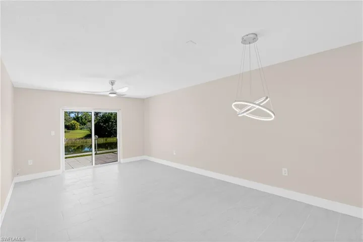 Unfurnished room featuring a water view and ceiling fan