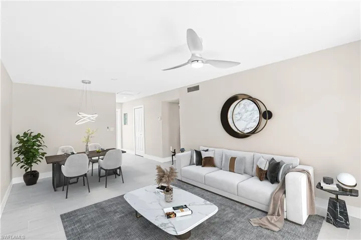 Living area featuring light tile patterned floors and ceiling fan