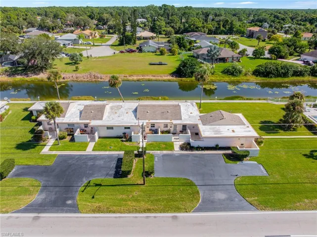 Aerial view of residential area featuring a large body of water