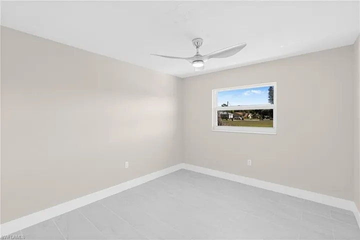 Spare room with baseboards and a ceiling fan
