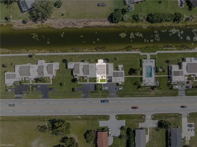 Aerial view of property's location with a nearby body of water