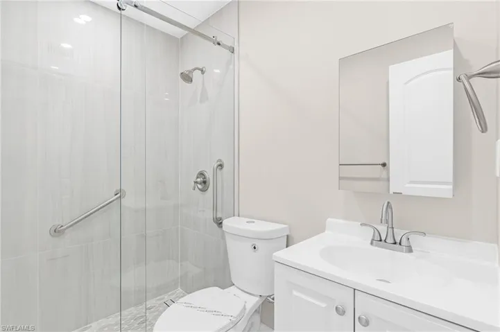 Bathroom with vanity and a stall shower