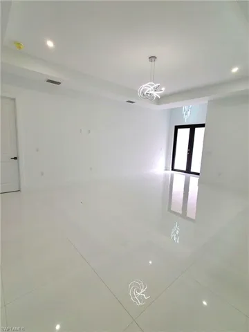 Unfurnished room featuring tile patterned floors and french doors