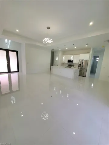 Unfurnished room with french doors and light tile patterned flooring