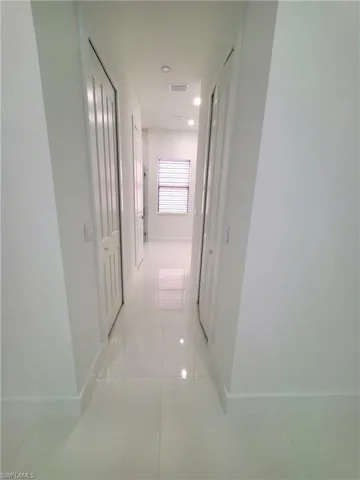 Hallway featuring light tile patterned flooring