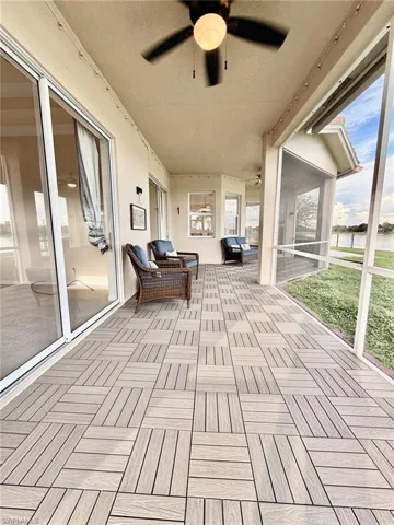 View of screened Lanai, ceiling fan, and a water views