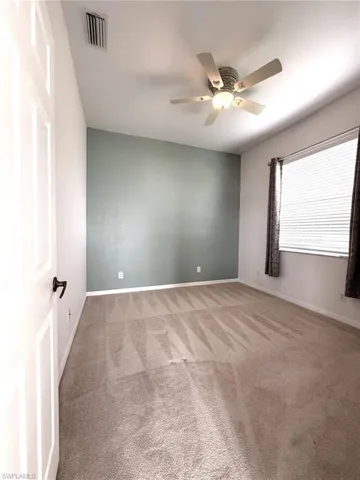 Bedroom featuring light colored carpet and ceiling fan
