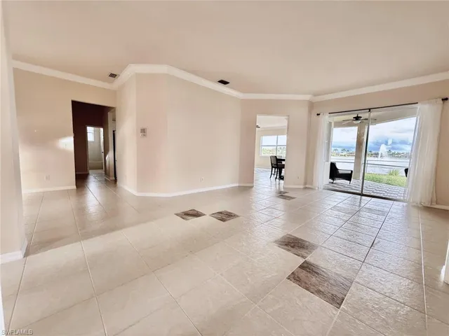 Living room featuring crown molding and a water view