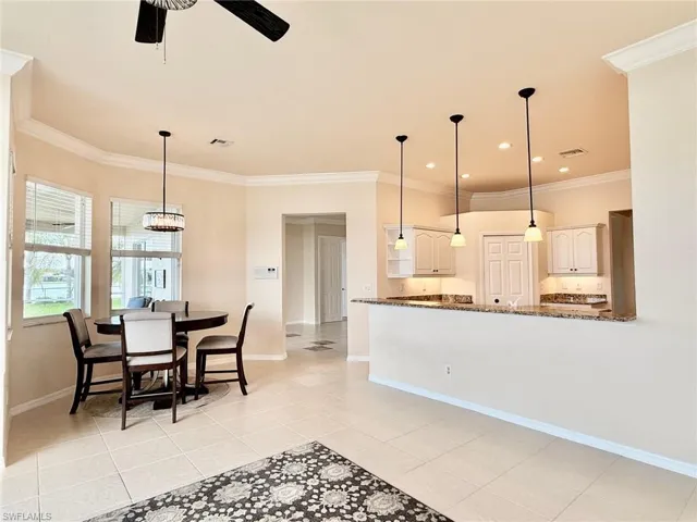 Dining space featuring crown molding, light tile patterned floors, a ceiling fan, and recessed lighting