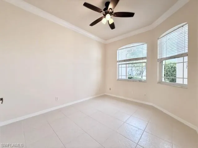 Dedicated home office featuring crown molding, ceiling fan, and light tile patterned floors