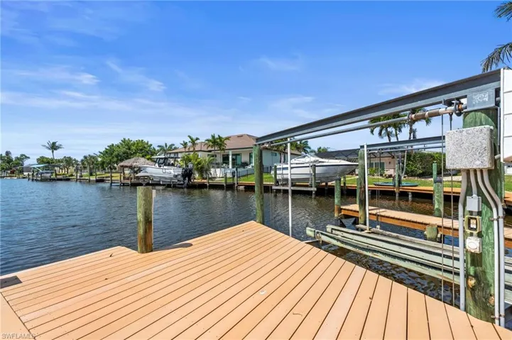 Dock area with boat lift and a water view