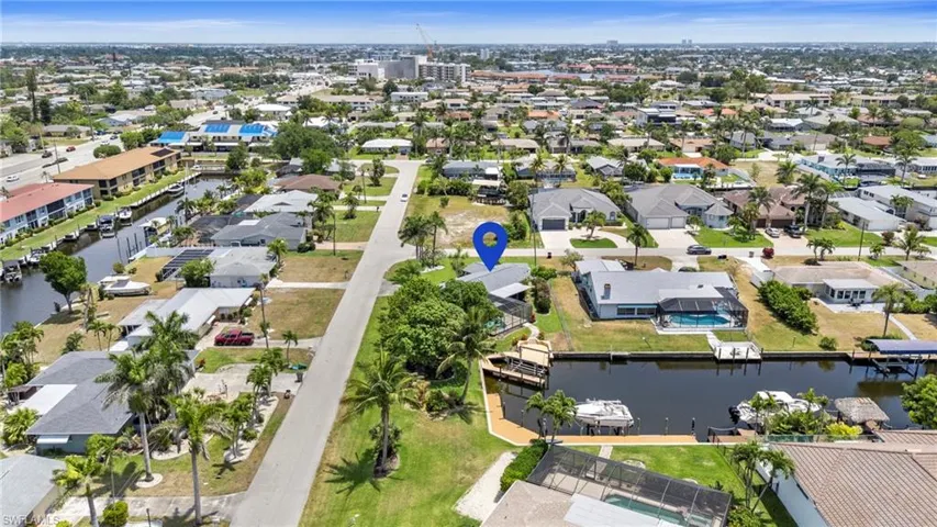 Aerial view of residential area featuring a nearby body of water