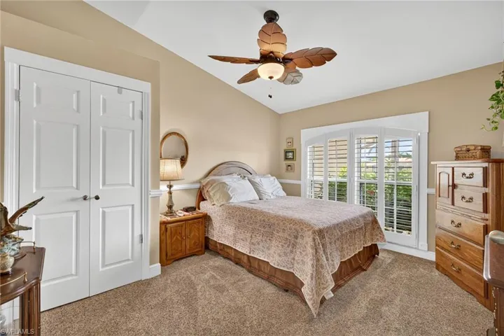 Bedroom 2 with carpet floors, lofted ceiling, ceiling fan, and a closet